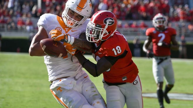 Georgia defensive back Deandre Baker (18) knocks the ball from Tennessee running back Jalen Hurd (1) just before he was about to score during the first half at Sanford Stadium on Oct. 1, 2016, in Athens, Ga.