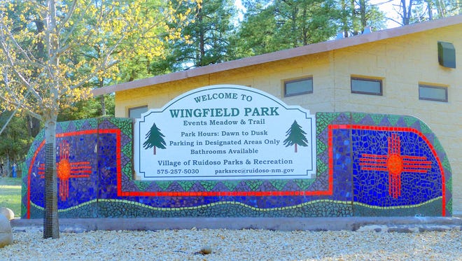 The sign describes the physical location of the park on Wingfield Street, but also denotes a founding family of the community.