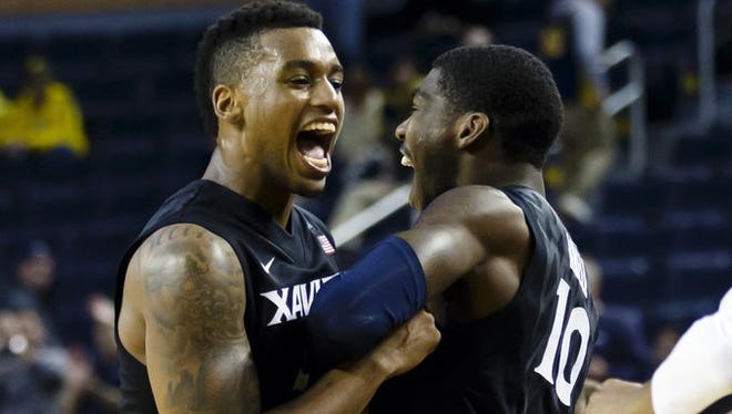 Trevon Bluiett (left), Remy Abell and the rest of Xavier's team will enter tonight's game against NKU as No. 23 in the Associated Press Top 25.
