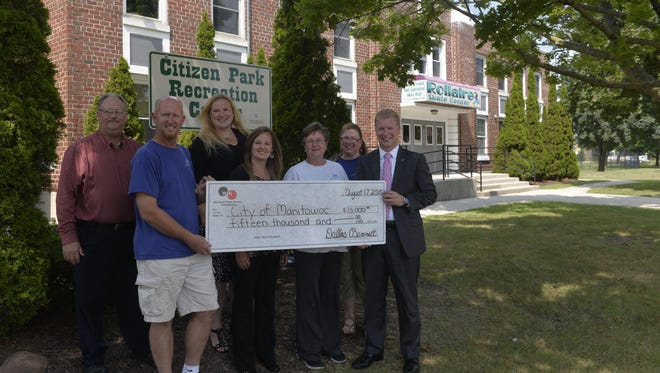 In this 2015 photo, Friends of Citizen Park Rec Center members Staate Hayward, John Brunner, April Selner, Nyla Pitsch, Lynn Lemberger and Manitowoc Mayor Justin Nickels are presented with a $15,000 grant from Dallas Bennett of Wisconsin Public Service.