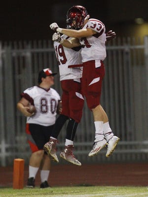 La Quinta High School's Derrick Kennedy and Oscar Navarro celebrate a touchdown against Indio High School.