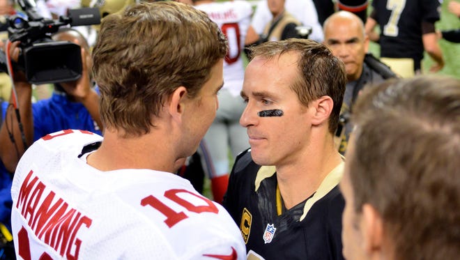 New York Giants quarterback Eli Manning (10) and New Orleans Saints quarterback Drew Brees (9) talk after the game at the Mercedes-Benz Superdome. New Orleans won 52-49 last year.