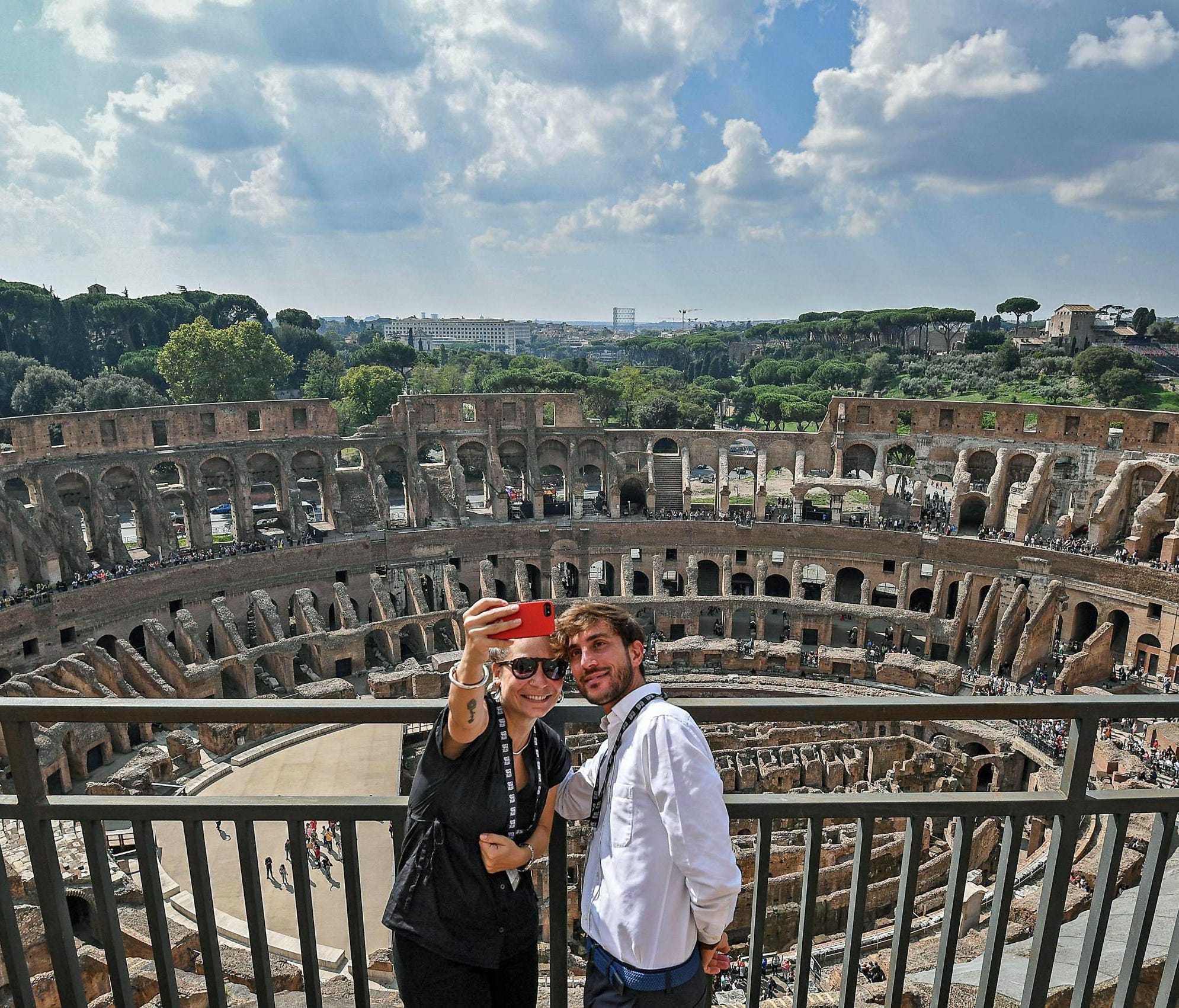 Two visitors take a selfie from the top level of the Colosseum during the re-opening after forty years of the fourth and fifth levels of the famed site, in Rome, Italy on Oct. 3, 2017. Officials showed off the newly restored levels of the Colosseum, 
