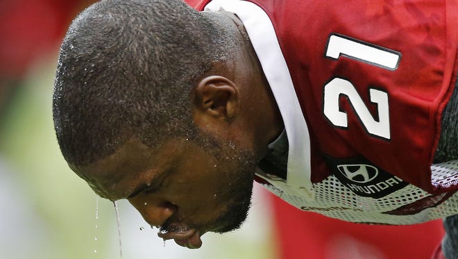 Cardinals CB Patrick Peterson cools off with water over his head during training camp at University of Phoenix Stadium in Glendale, Ariz. July 27, 2014.