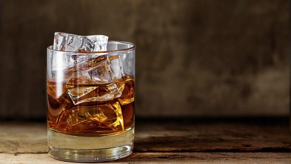 A glass of whiskey with ice.