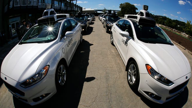 A group of self driving Uber vehicles position themselves to take journalists on rides during a media preview at Uber's Advanced Technologies Center in Pittsburgh, Sept. 12, 2016.