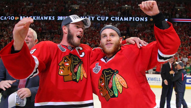 Chicago Blackhawks captain Jonathan Toews celebrates with right wing Patrick Kane after winning the Stanley Cup.