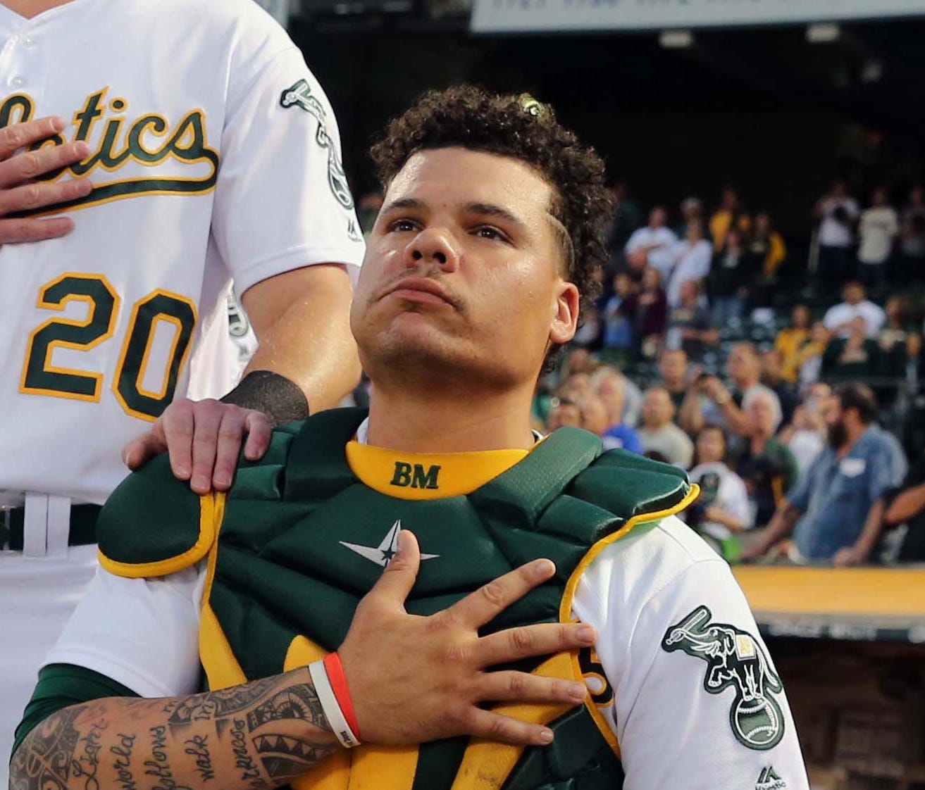 Athletics catcher Bruce Maxwell takes a knee during the national anthem before a game against Seattle on Sept. 25.
