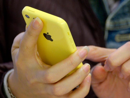 A 2013 file photo shows a person using an Apple iPhone