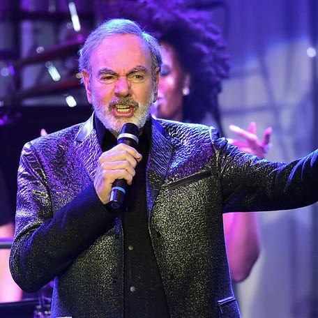 (FILES) This file photo taken on February 11, 2017 shows singer Neil Diamond performing during the annual Clive Davis pre-Grammy gala at the Beverly Hilton Hotel.  Diamond announced on his website on January 22, 2018, he has been diagnosed with Parkinson's disease. He also announced his retirement.  / AFP PHOTO / Frederic J. BROWNFREDERIC J. BROWN/AFP/Getty Images ORIG FILE ID: AFP_XJ59W
