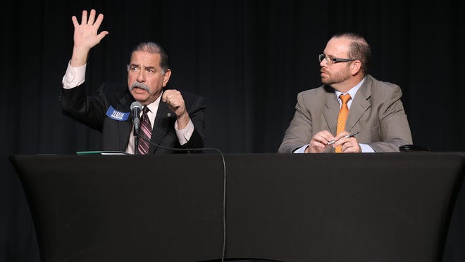 County Commissioner Precinct 2 David Stout, right, listens as his opponent, former County Commissioner Sergio Lewis, fields a question during the candidate forum Feb. 7 at the El Paso Community College Transmountain Campus.