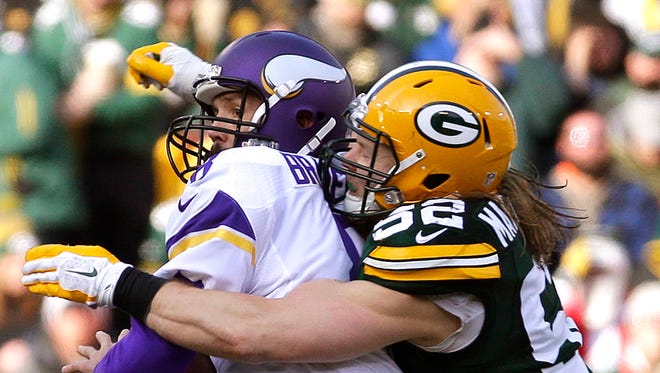 Green Bay Packers outside linebacker Clay Matthews (52) sacks Minnesota Vikings quarterback Sam Bradford (8) to force a fumble in the second quarter of the game, Saturday, December 24, 2016 at Lambeau Field in Green Bay.