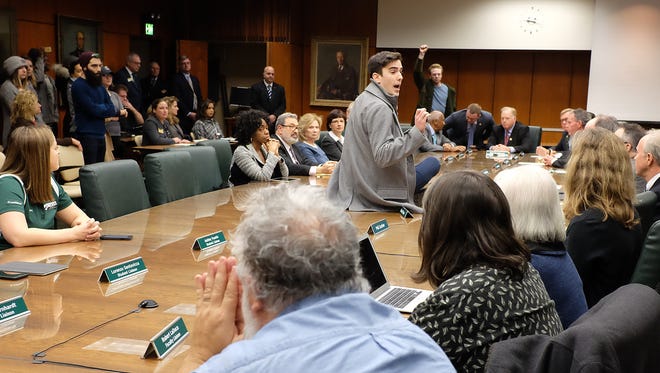 MSU senior Connor Berdy protests at the MSU Board of Trustees meeting Wednesday, Jan. 31, 2018 in East Lansing, Michigan. 