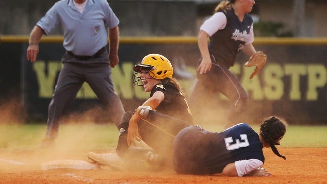 Bishop Verot High School’s Madison Clinger slides safely into third base against Delray Beach American Heritage on Thursday at Sam Fleishman Park in Fort Myers. Verot beat Heritage 14-2 in the Class 4A regional semifinal softball game.
