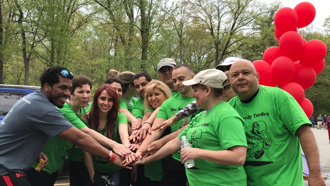 Members of the team the Speedy Turtles rally together at the New Jersey 2018 AIDS walk at the Ridgewood Duck Pond in Saddle River County Park on May 6, 2018.