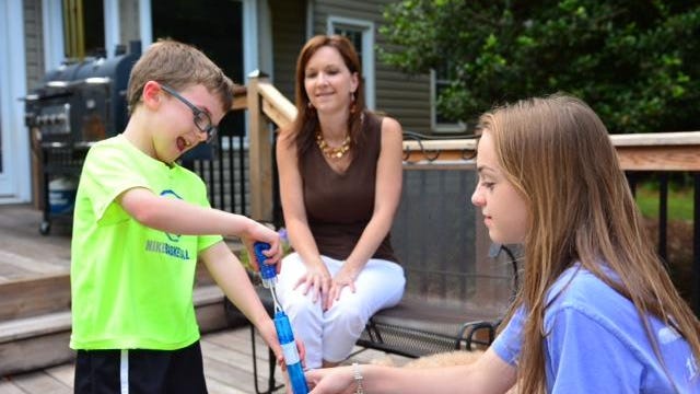 Brayden, left enjoys playing bubbles with his sister, Erika, 13, as mom, Sabra Bateman watches. The Bateman family will represent South Carolina in hosting a lemonade stand on June 13 to raise money for the Alex’s Lemonade Stand Foundation for Childhood Cancer.