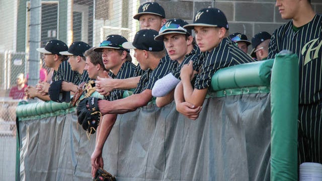 Woodward-Granger baseball players watch from the dugout during the season opener on Monday, June 15. PHOTO BY SEAN CORDY/THE PERRY CHIEF