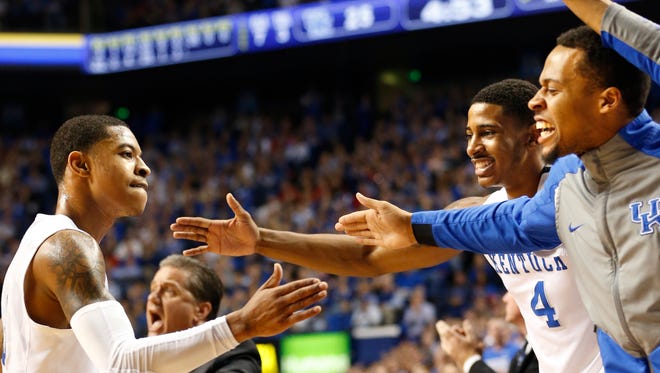 Kentucky's Tyler Ulis, left, celebrates with Isaiah Briscoe, right, and Charles Matthews. Dec. 26, 2015 