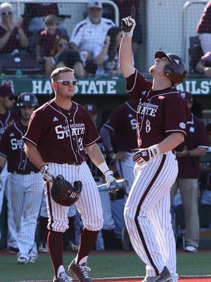 Mississippi State catcher Gavin Collins points to the sky after hitting a home run against LSU.