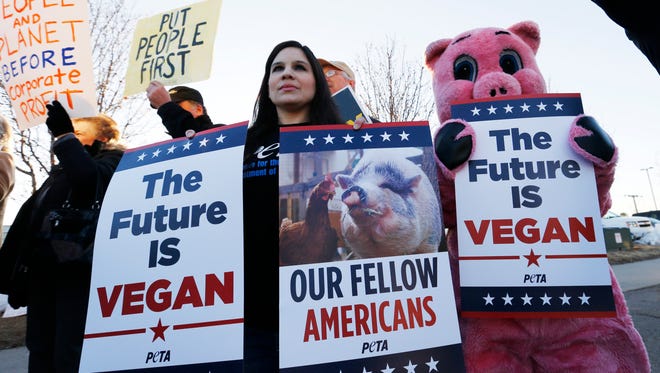 Members of PETA demonstrate Saturday, March 7, 2015, outside the Iowa Ag Summit in Des Moines.