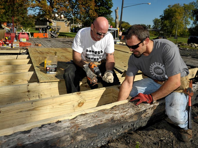 Bob Rawlings, left, 57, of Rochester, and Brian MacIborski, 33, of Shelby Twp., install floor joists.
