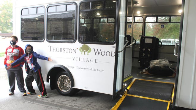 Tommy and Frank Drumm stopped by Thurston Woods Village to see the new bus they wanted to support.