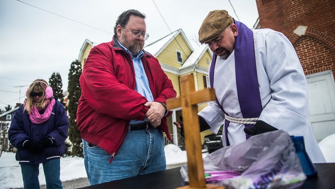 Randy Martz, of Hanover, receives ashes from Pastor Terrence McCarthy outside of St. Paul Evangelical Lutheran Church on Broadway on Feb. 10, 2016. 