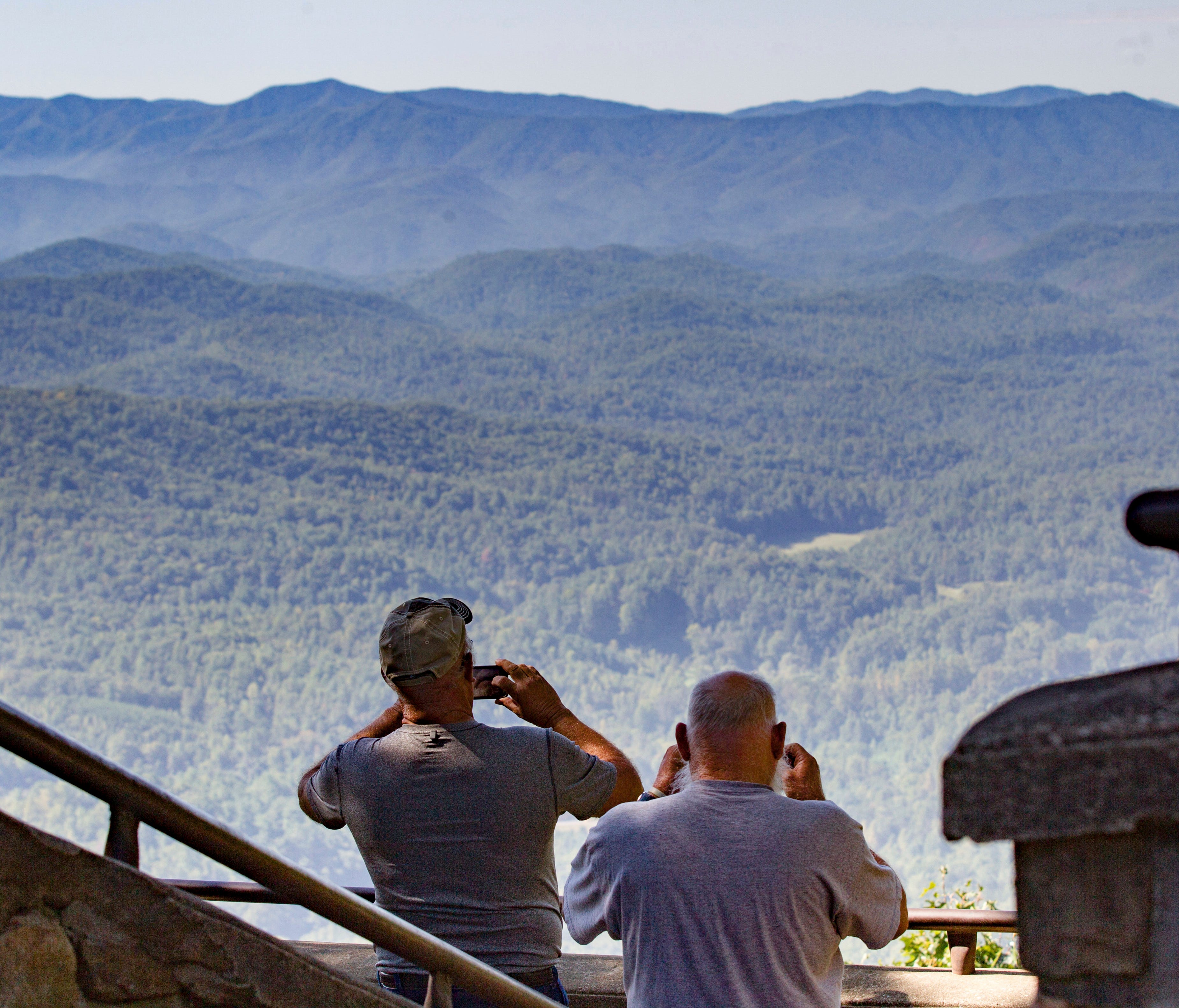 In this Sept. 15, 2016, photo, visitors take pictures of the Great Smoky Mountains National Park from a lookout point on the Foothills Parkway near Chilhowee, Tenn. Work is underway to complete the extension of scenic route running near the northern 