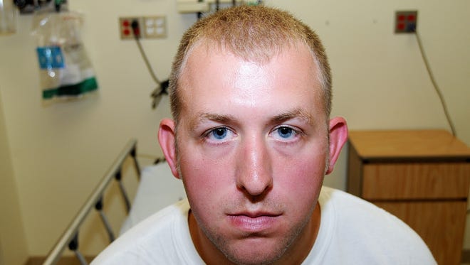 This undated file photo released by the St. Louis County Prosecuting Attorney's office shows Ferguson police officer Darren Wilson during his medical examination after he fatally shot Michael Brown, in Ferguson, Mo. Wilson’s resignation was announced Saturday by one of his attorneys, Neil Bruntrager. Bruntrager said the resignation is effective immediately.