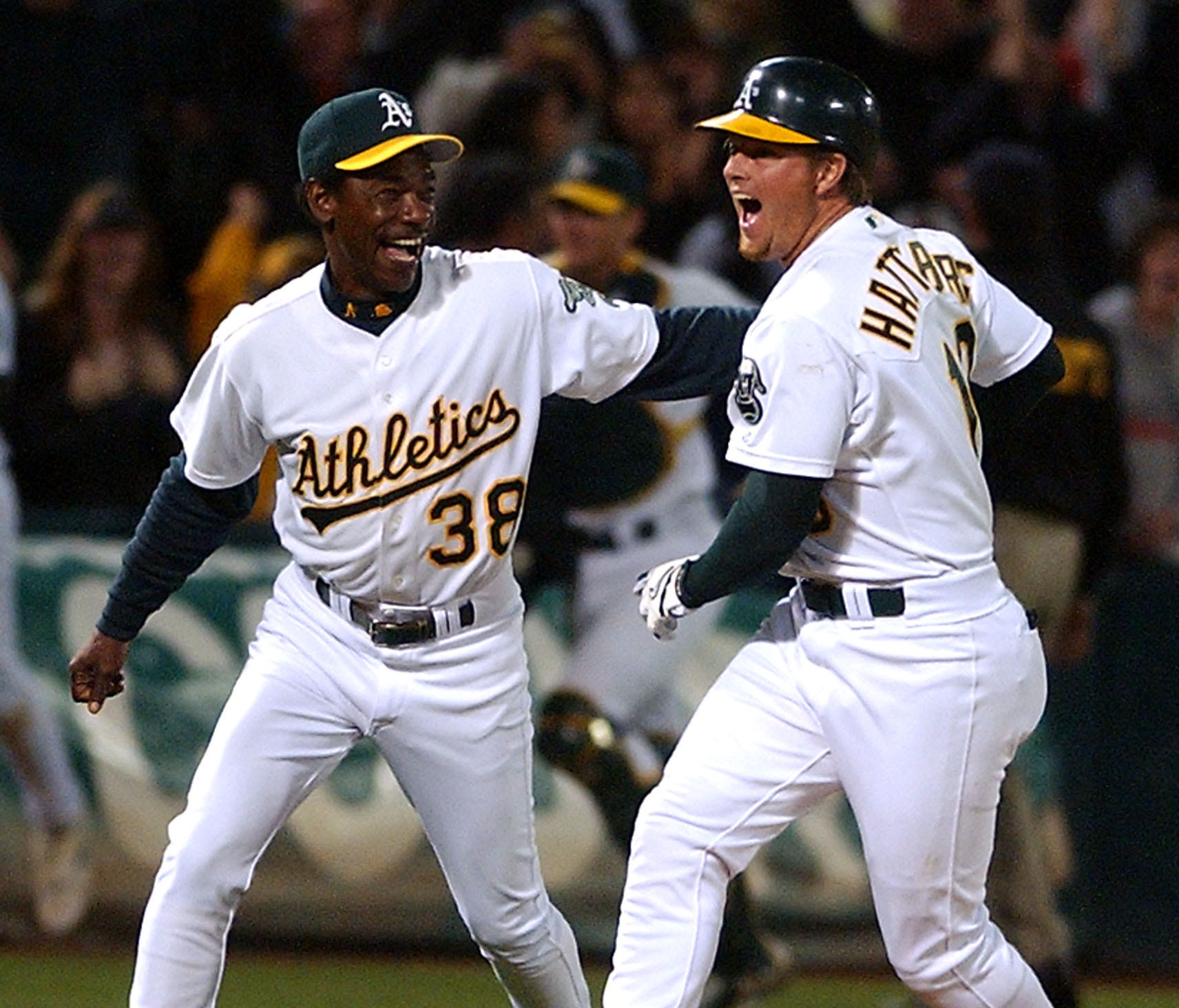 Scott Hatteberg, right, celebrates with third base coach Ron Washington after hitting the game-winning home run to ensure Oakland's 20th consecutive victory in 2002.