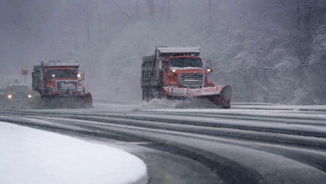 DelDOT plow trucks remove falling snow from Lancaster Pike on Wednesday afternoon.
