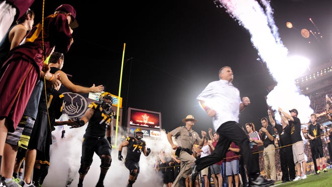 ASU football head coach Todd Graham leads his team onto the field before the game against UCLA on Sept. 25, 2014, at Sun Devil Stadium in Tempe.