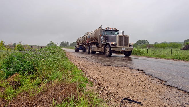A tanker truck travels on FM 2067 between Austin and Victoria on April 18, 2018. Texas counties are asking state leaders to help pay for road damage caused by heavy traffic from the oil and gas industry.