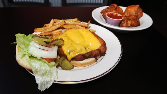 The deep-fried burger, which is a 3-ounce breaded beef patty with cheese, lettuce, tomato, onions and pickles, and mushrooms are a popular choice at the Angry Bull Saloon on Linden Avenue in Zanesville.