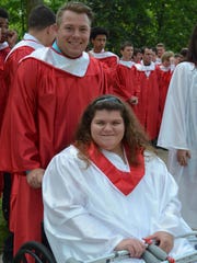 Michael Panichelle, 18, of Sewell, pushed Antonia Angelo, 18, of Clementon in a wheelchair for the traditional walk from St. Joseph High School to Saint Joseph's Church for the Baccalaureate Mass held on May 31.