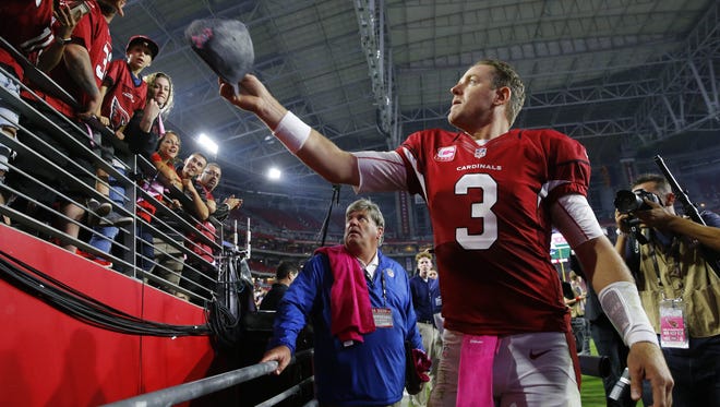 Cardinals quarterback Carson Palmer (3) tosses his cap to a fan following their win over the Jets, Monday, Oct. 17, 2016 in Glendale, Ariz.