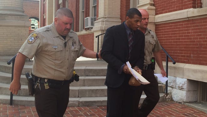 Michael T. Williams, 20, is led from court Thursday following the first day of his two-day murder trial.