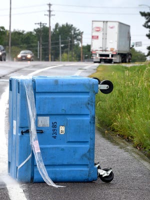 A semi-truck is parked at the top of a hill Tuesday morning on Range Line Street after the truck lost 10 containers of dry ice on the road.