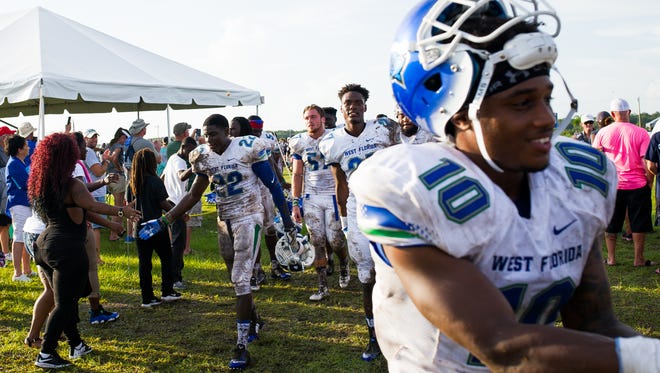 UWF players leave the field and get welcomed by supporters after their inaugural football game on Sept. 3, 2016 in a 45-0 victory against Ave Maria University in Naples.