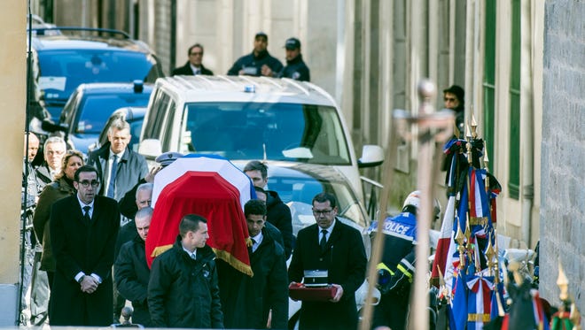 The funeral convoy of Col. Arnaud Beltrame arrives outside the Carcassonne cathedral Thursday, March 29, 2018 in Carcassonne, southern France.