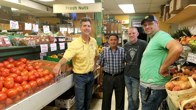 The Produce Place owner Barry Burnette (left)  says his longtime employees are keys to his success. Burhan Sadiq ,Steve  Marshall and Eric Morrison (right) have all been with the store for 26 of its 30 years.