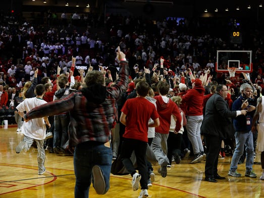 Dec. 5: Nebraska Cornhuskers fans run on the court