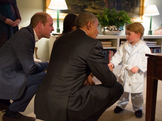   At his first royal rally, the little prince, dressed in a bathrobe and monogrammed slippers, spent his time squeezing The hand of President Barack Obama at Kensington Palace on April 22, 2016. 
