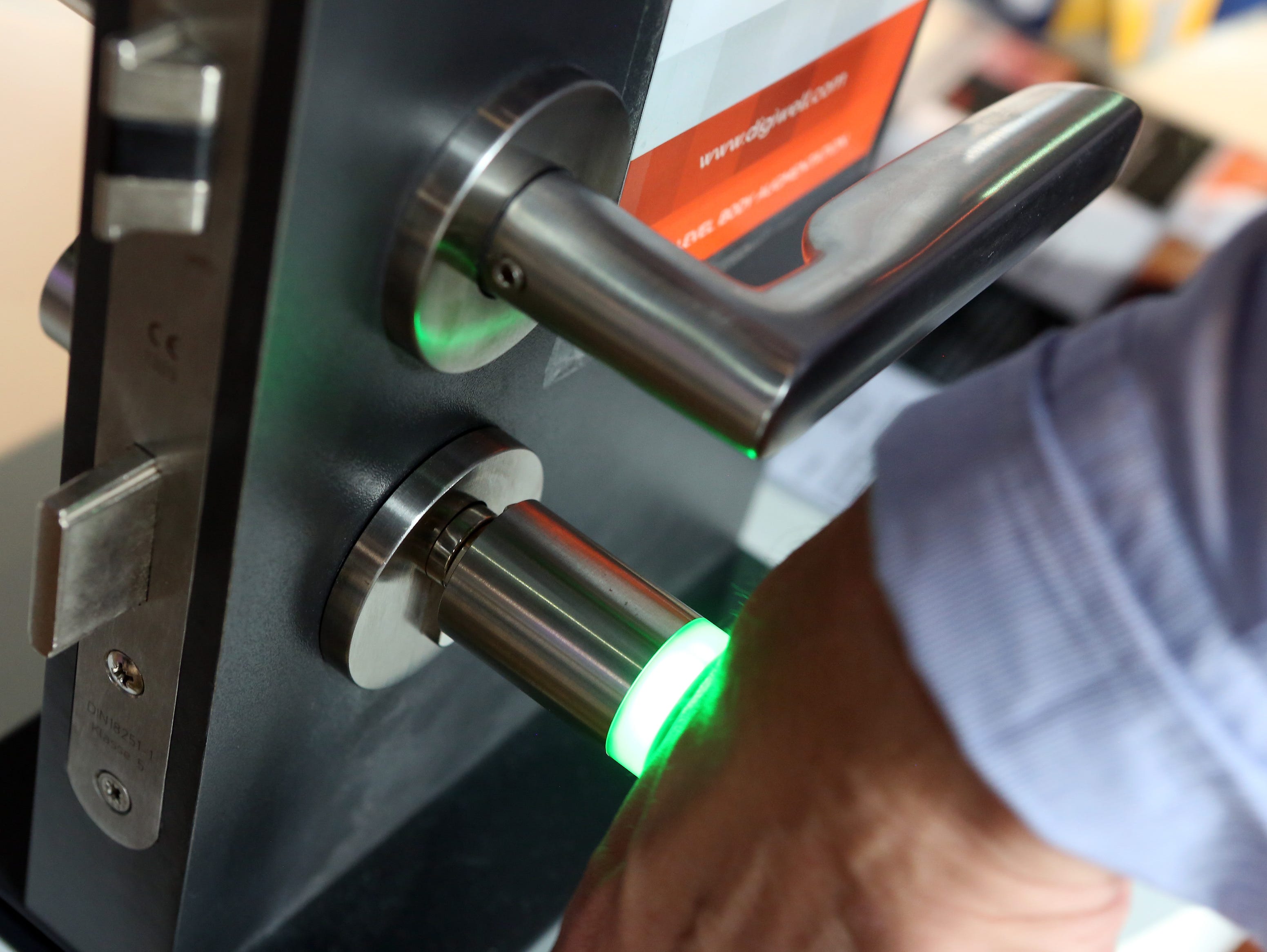 Patrick Kramer of the company Digiwell uses the microchip implanted in his hand to open a door lock at a press preview of the Wear-it festival in Berlin on June 8, 2017.nThe Wear It Festival takes place on June 8 and 9, 2017 in Berlin and shows the p