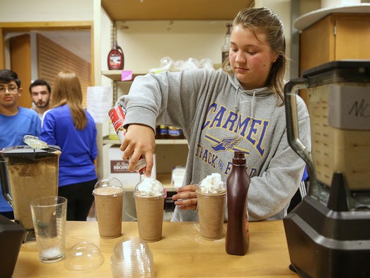 Junior Hannah Radde, 16, adds whip cream to frappucinos