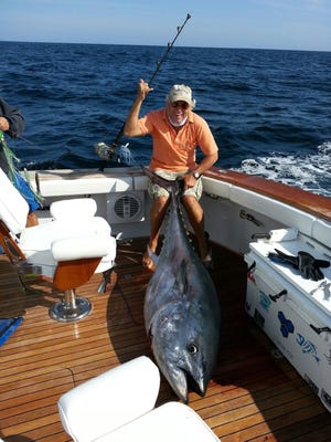 Jimmy Buffett is happy after reelig in a 350-pound tuna off the Nantucket waters Wednesday.