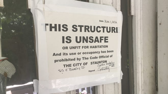 This sign is posted on the padlocked front door of a condemned home on East Beverley Street in Staunton.