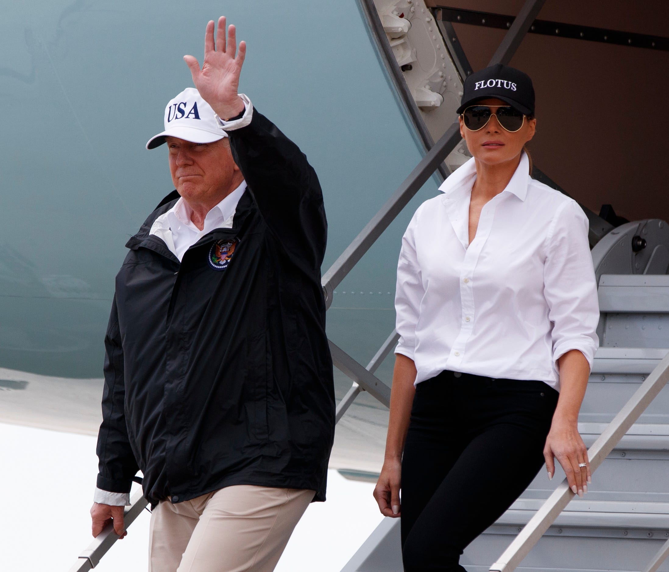 President Trump, accompanied by first lady Melania Trump, waves as they arrive on Air Force One at Corpus Christi International Airport Tuesday.
