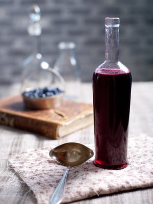 Old wine bottle with homemade berry vinegar.