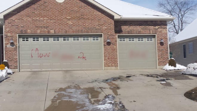 This photo, which has been altered to obscure a racial slur and the name of a hate group, shows the message that was left on Dr. Myla Bennett’s Sandbrige Drive home on Feb. 24.